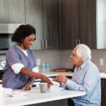 care giver making breakfast for a seniors