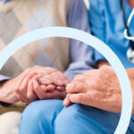 doctor holding seniors hand