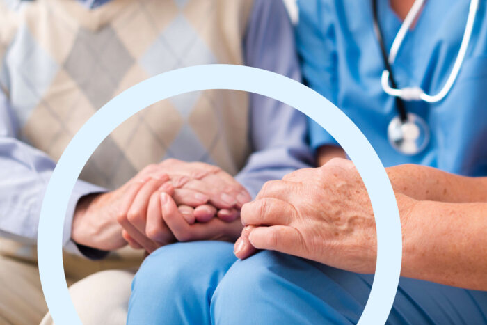 doctor holding seniors hand