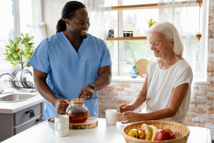 A caregiver and a senior are preparing breakfast together.